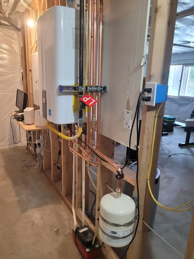 Licensed plumber repairing a kitchen sink in Neptune